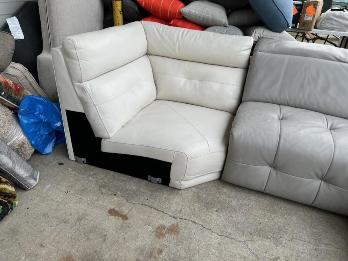 White Leather Wedge-Shaped Corner Chair with Tufted Accents